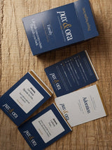 Catholic Prayer Cards — Pax & Ora family pack with navy blue tuck box and prayer prompt cards on textured surface.