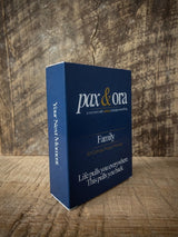 Catholic Prayer Cards — Pax & Ora Family Pack in a blue tuck box with white text on a rustic wooden background.