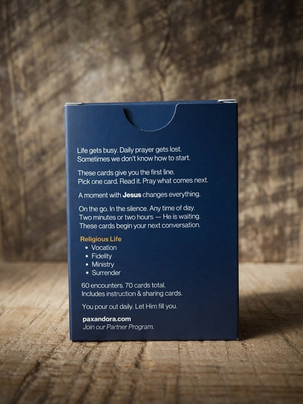 Catholic Prayer Cards — Pax & Ora navy blue tuck box with white text on a rustic wooden background.