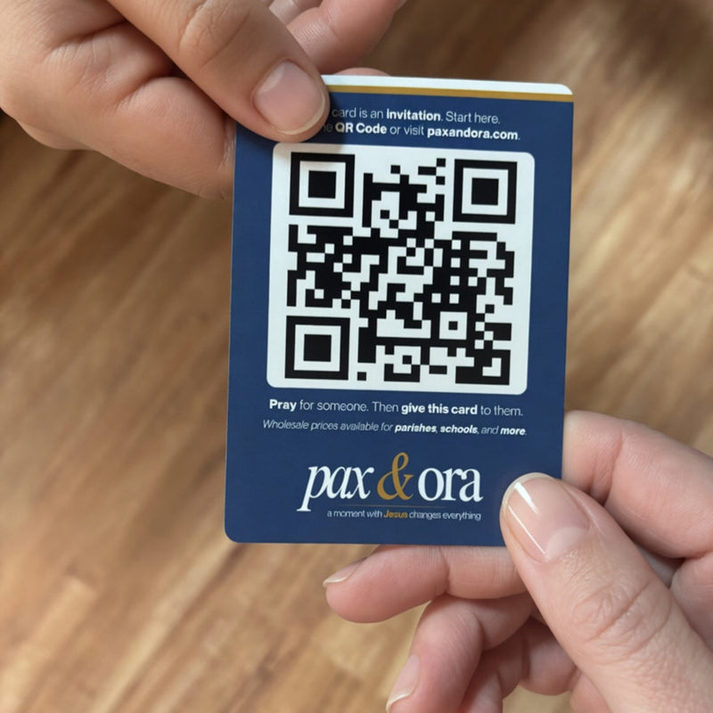 Catholic evangelization cards Pax and Ora Share Pack — prayer card held in hand
